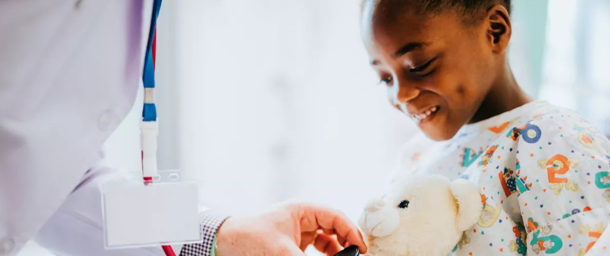 Young girl in hospital gets her teddy bear's heart rate checked